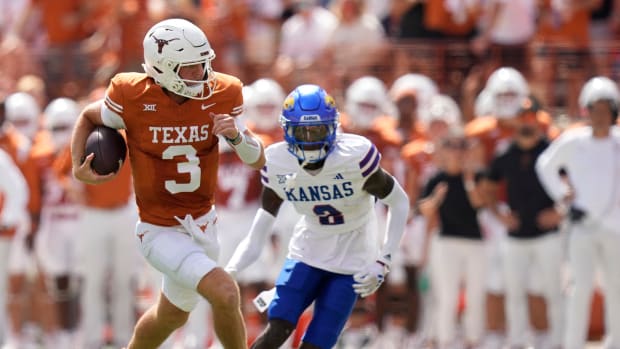 Texas Longhorns quarterback Quinn Ewers runs past Kansas Jayhawks cornerback Cobee Bryant for a touchdown in the first quarter at Royal-Memorial Stadium on Saturday September 30, 2023.